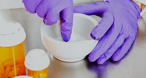 a person compounding a medicine